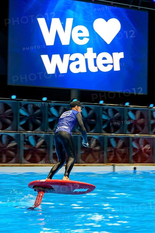 Press photo dynamic photo of eFoil surfer in the large XXL pool in Hall 17 of Messe Boot Düsseldorf, in the background the motto of Messe boot We Love Water, Messe Boot, Düsseldorf, North Rhine-Westphalia, Germany