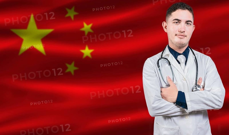 Portrait of medical professional on China flag background. Chinese national health system