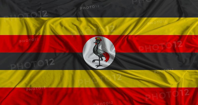 Uganda flag with fabric texture background. National flag of Uganda with cloth texture