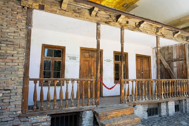 Rustic wooden veranda of a building with old wooden windows, birthplace of Josef Stalin, Gori, Inner-Kartli region, Georgia