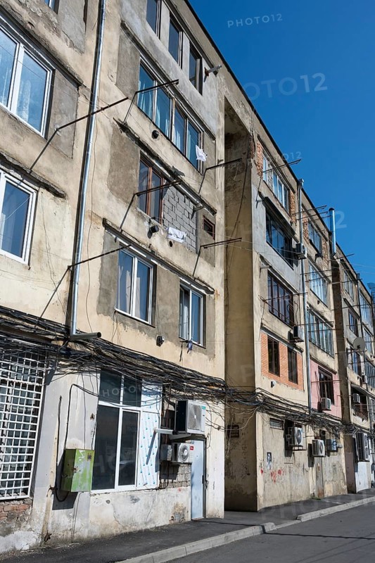 Multi-storey apartment unit with visible cables and worn exterior façade, Gori, Inner Kartli region, Georgia