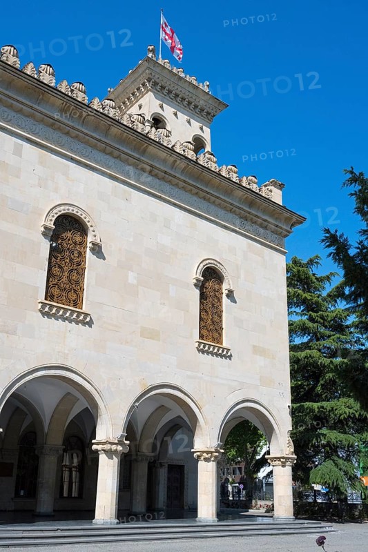Historic building with decorated façade and a flag against a blue sky, Josef Stalin Museum, Gori, Inner Kartli region, Georgia