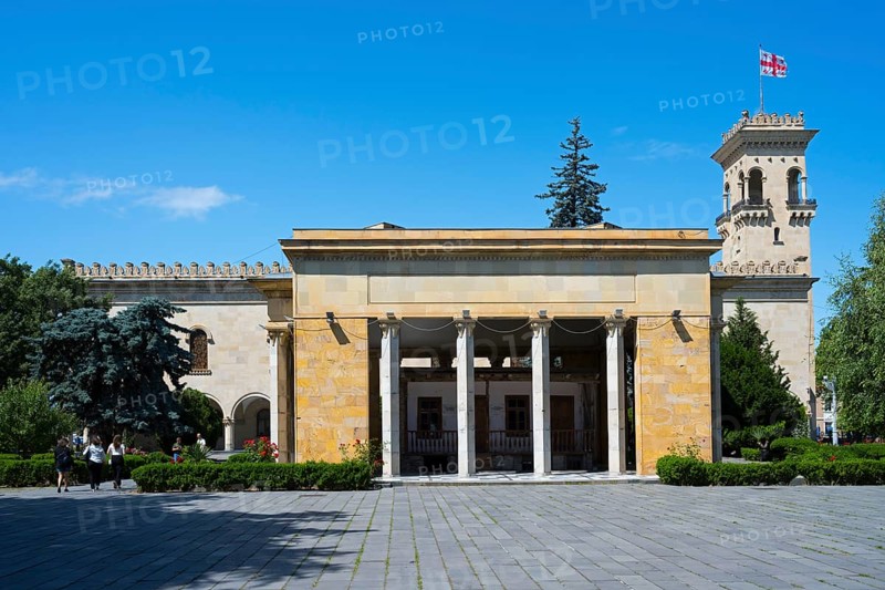 Historic building with columns and Georgian flag in clear blue sky, Josef Stalin Museum, Gori, Inner Kartli Region, Georgia