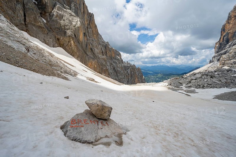 Guide to Rifugio Brentei on a rock, remains of the Vedretta dei Camosci glacier, Brenta Mountains, Brenta-Adamello Natural Park, Trentino, Italy