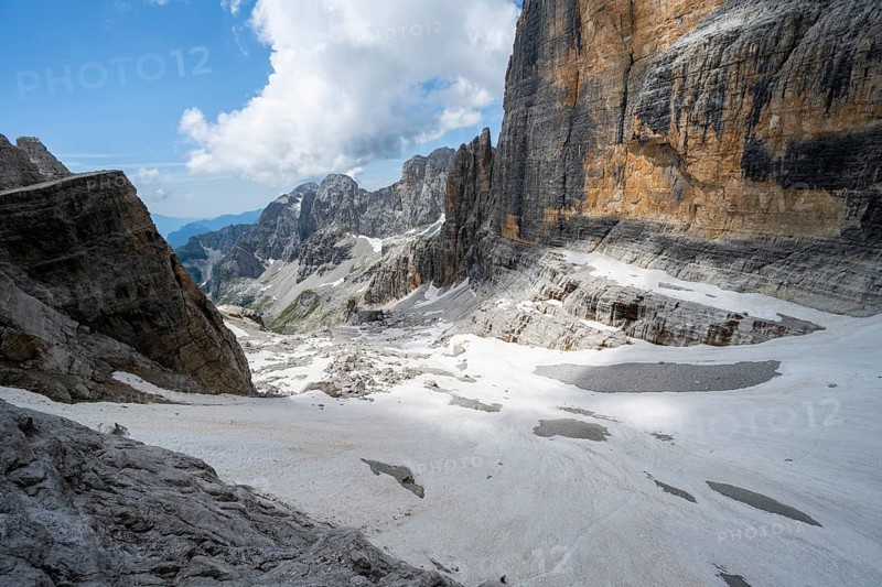 Spectacular mountain landscape with steep cliffs and remains of the Vedretta d'Ambiez glacier, Via Ferrata Brentari via ferrata, Brenta Mountains, Parco Naturale Brenta-Adamello, Trentino, Italy