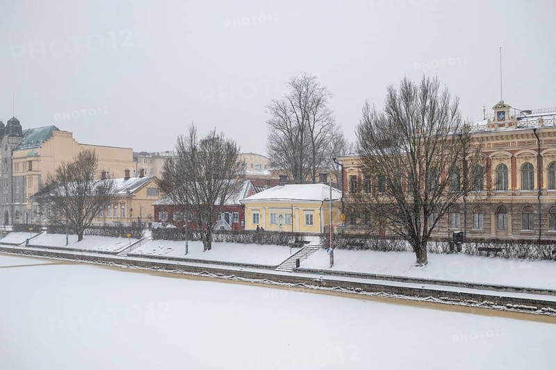 Pharmacy museum and other historic buildings on the frozen Aurajoki river, wintery Turku or Swedish Åbo, Varsinais-Suomi, Finland