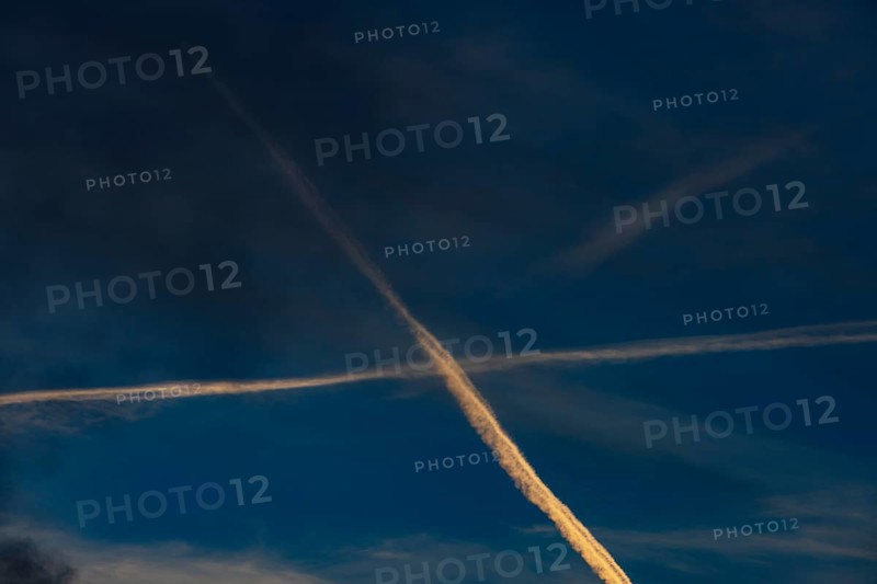 Contrails cross in the evening sky, Upper Austria, Austria