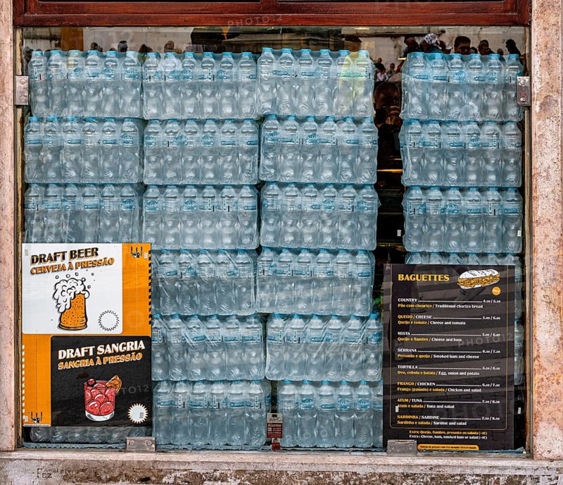 Stacks of seltzer bottles in a bar window, Sintra, Lisabon, Portugal