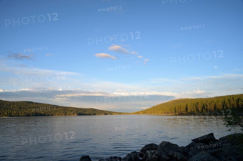 Extensive view of peaceful Lake Gutulsjön under clear evening sky, Gutulia National Park, Engerdal, Innlandet, Norway