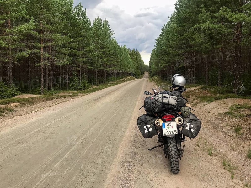 Torsby, Värmlands län, Sweden, BMW G 650 GS Sertao Enduro motorcycle stands on a secluded forest path surrounded by thick forest