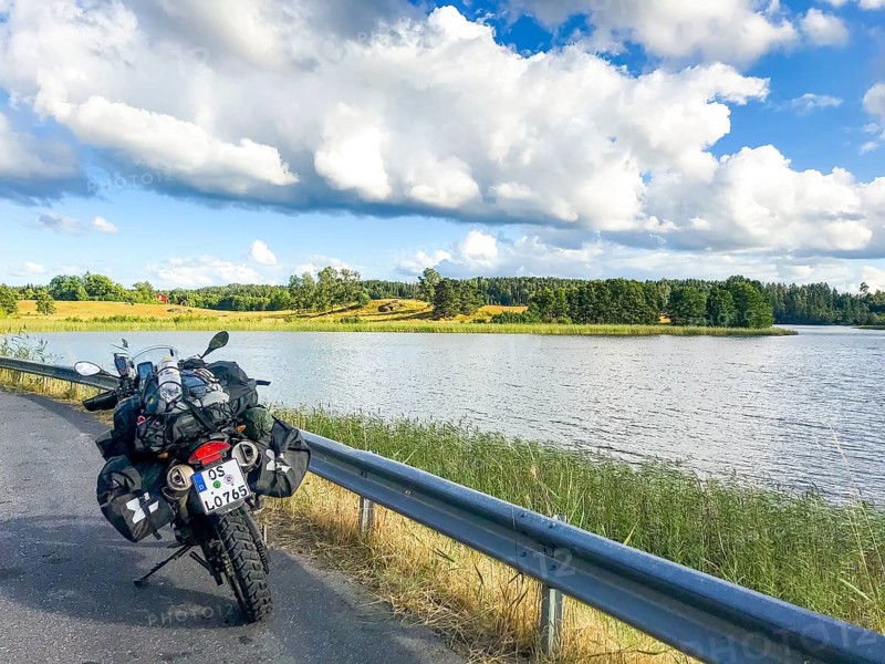 Sparreholm, Södermanlands län, Sweden, BMW G 650 GS Sertao Enduro motorcycle on a country road next to a lake under a cloudy sky