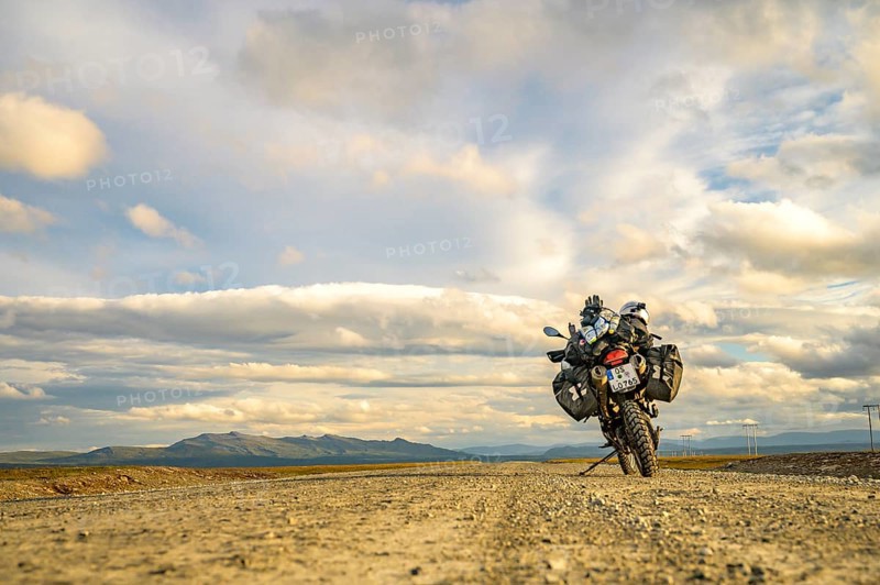 Falkvålen, Bruksvallarna, Jämtland, Sweden, BMW G 650 GS Sertao enduro motorcycle on gravel road against mountainous backdrop under dramatic skies, endless adventure