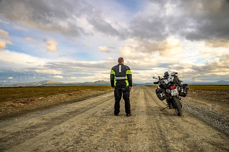 Falkvålen, Bruksvallarna, Jämtland, Sweden, BMW G 650 GS Sertao Enduro motorcyclist standing on a secluded country road, ready for adventure under cloudy skies