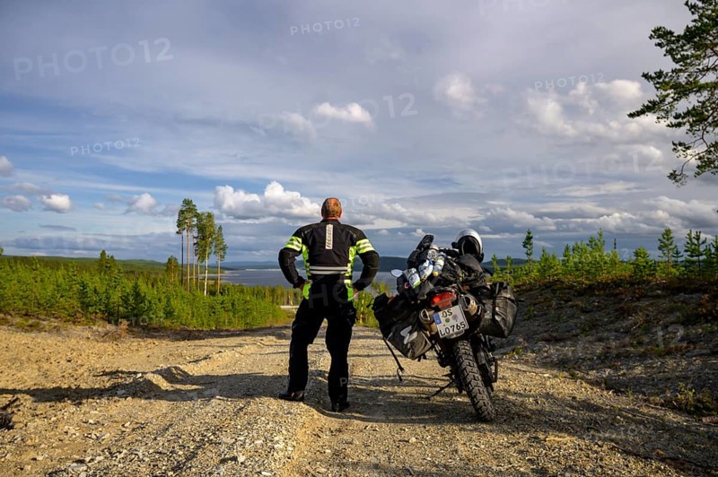 Lövdalen, Jämtland County, Sweden, BMW G 650 GS Sertao Enduro motorcyclists on dirt road looking at the landscape and the sky