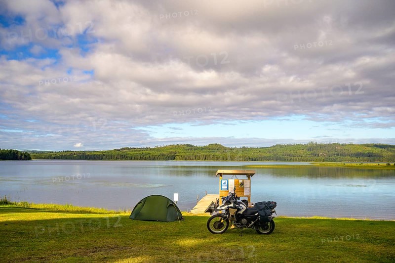 Rörström, Dorotea, Västerbotten, Sweden, tent and BMW G 650 GS Sertao Enduro motorcycle on a campsite on Innlandsvägen on a lake under a partly cloudy sky in nature