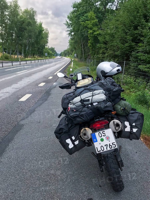 Broby, Skåne län, Sweden, BMW G 650 GS Sertao enduro motorcycle on a road with bags packed for a trip surrounded by trees