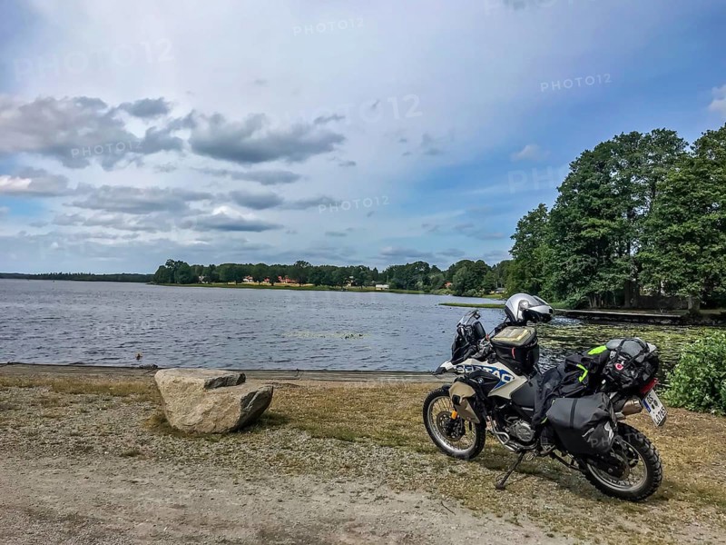 Urshult, Kronobergs län, Sweden, BMW G 650 GS Sertao enduro motorcycle next to a lake under cloudy sky with natural surroundings