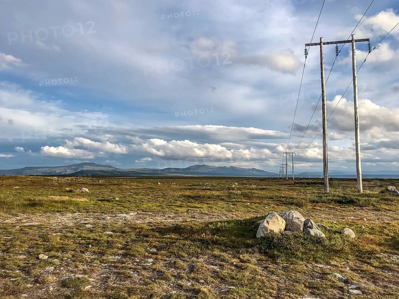 Ljungdalen, Jämtlands län, Sweden, wide landscape with electricity poles on the horizon under a cloudy sky