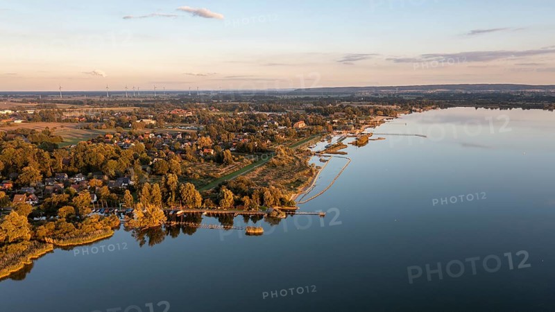 Lembruch, Lower Saxony, Germany, view of Lake Dümmer with adjacent weekend house settlements and harbours in the foreground and the outflow of the river Lohne at dusk, calm water with reflections, aerial view