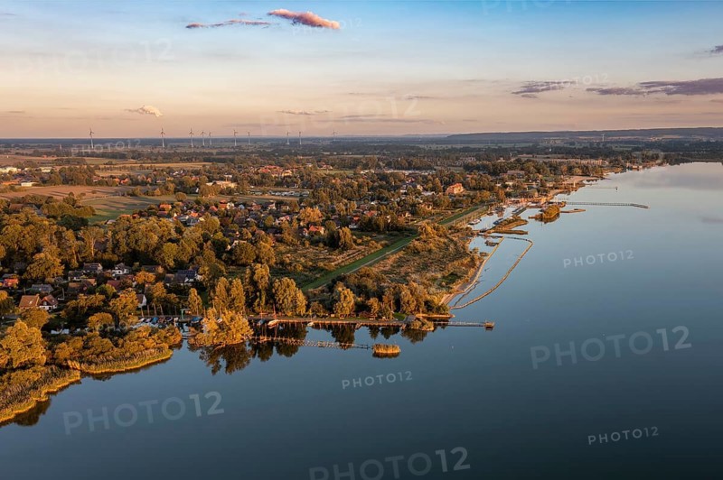 Lembruch, Lower Saxony, Germany, Dümmer See at the outflow of the river Lohne with shore and village at sunset, calm water with warm light, aerial view
