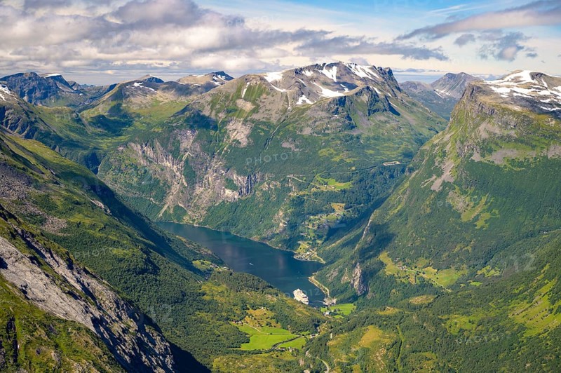 Geiranger, Møre og Romsdal province, Norway, view of the Geiranger fjord with a cruise ship nestled in a wide mountain valley, highest fjord view in Europe from the Geiranger Skywalk