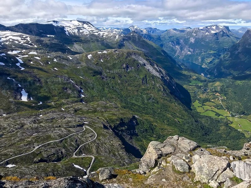 Geiranger, Møre og Romsdal province, Norway, view of a winding road in a deep, green mountain gorge above the Geiranger Fjord, highest fjord view in Europe from the Geiranger Skywalk