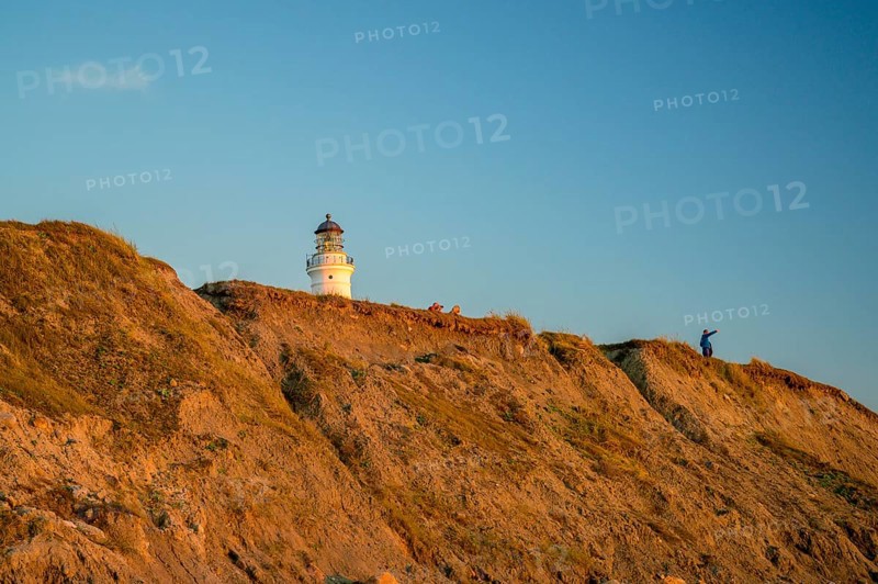 Hirtshals, Nordjylland region, Denmark, Hirtshals lighthouse stands on cliff in warm evening light
