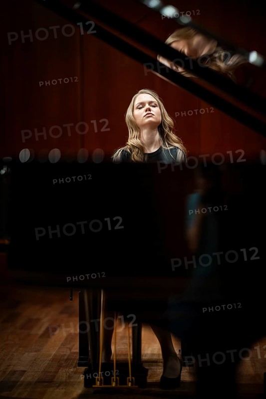 Young woman, pianist, with concentrated facial expression and closed eyes playing on a Steinway & Sons grand piano, Stuttgart, Baden-Württemberg, Germany