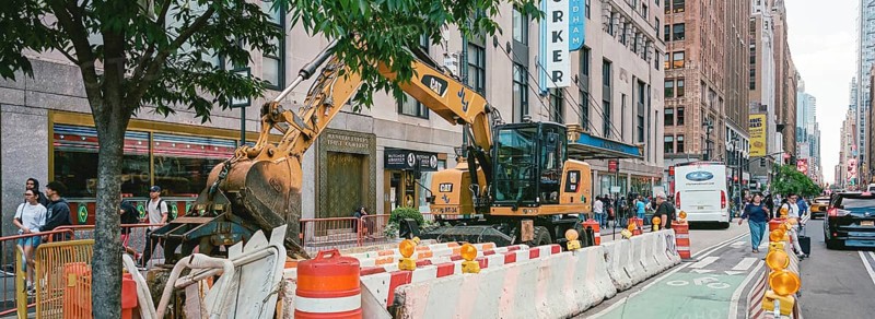 Excavator in front of the New Yorker Hotel, New York, USA