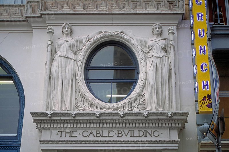 Two female sculptures above the entrance to the historic Cable Building, built in 1894 in Beaux Arts style, 611 Broadway, New York City, USA