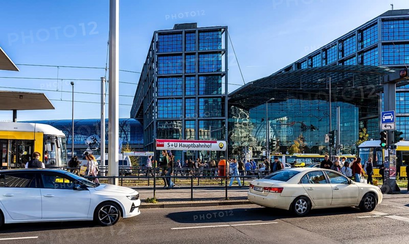 Berlin road traffic with buses, trams and pedestrians at and around the main train station, Berlin, Germany
