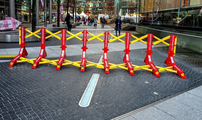 Massive metal access barriers in red and yellow at Center Potsdamer Platz, Berlin, Germany