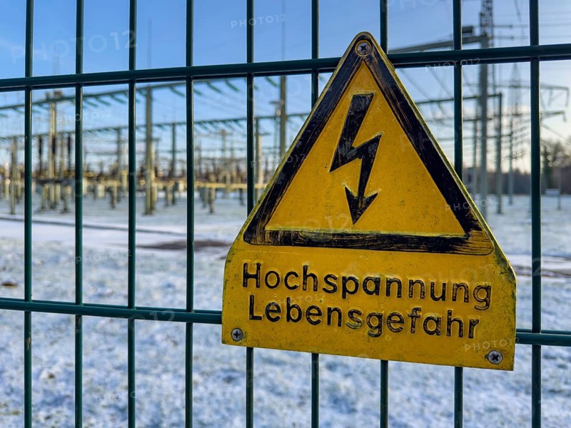 Recording of snow in winter warning sign warning high voltage danger to life on fence from behind substation substation substation substation part of electrical supply network with transformer generator in the background high-voltage lines high-voltage pole for secure energy supply Power supply, Germany