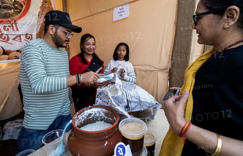 Vendor selling curd and cream dairy product at a stall in Bhogali Mela, ahead of the 'Magh Bihu' festival, in Guwahati, Assam, India on January 12, 2026. Magh Bihu, also called Bhogali Bihu, is Assam's harvest festival marking the end of the agricultural season and celebrated with feasts, community bonfires, and traditional food