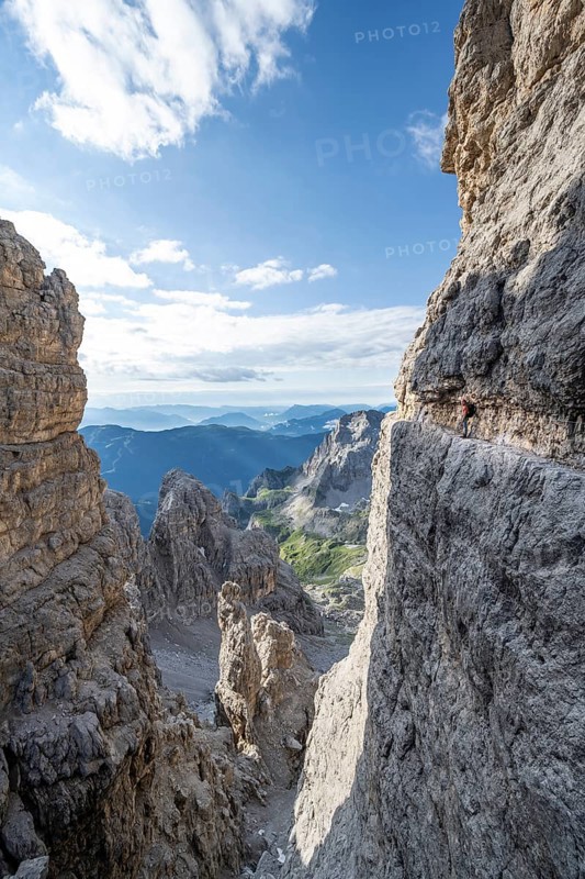 View from the Bocca degli Armi gap, mountaineers on a rock band on the Via Ferrata Bocciere Centrale via ferrata, Brenta Mountains, Brenta-Adamello Natural Park, Trentino, Italy