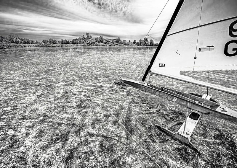 Ice sailors on water in black and white with strong contrast and structure, Dümmer nature park Park, Lower Saxony, Germany