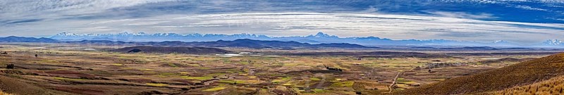 Extensive panorama with mountains and fields under cloudy sky, The Altiplano landscape in the Andes of Bolivia