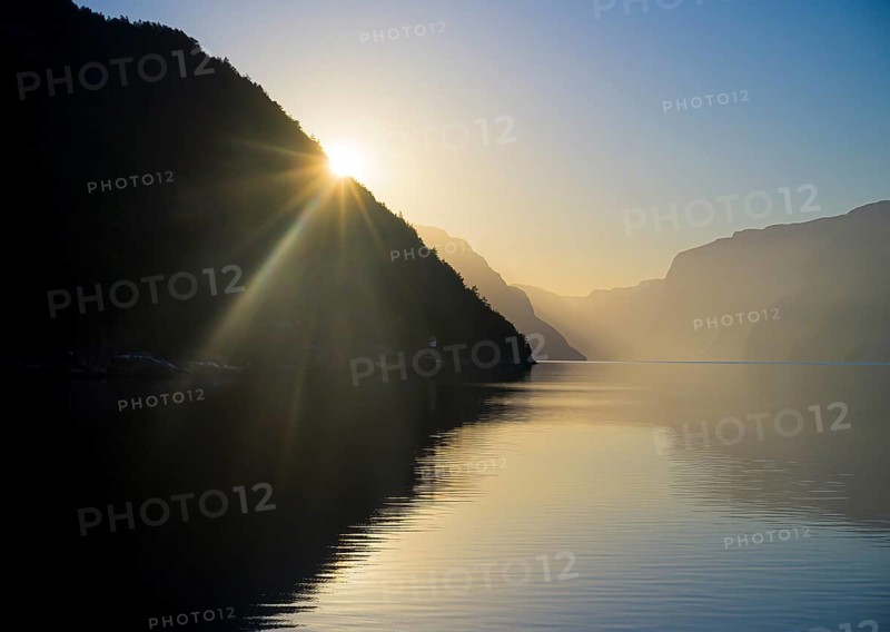 Sunset over the early morning Lysefjord with silhouetted mountains and a warm atmosphere, near Lysebotn, Ryfylke, Rogaland, Norway