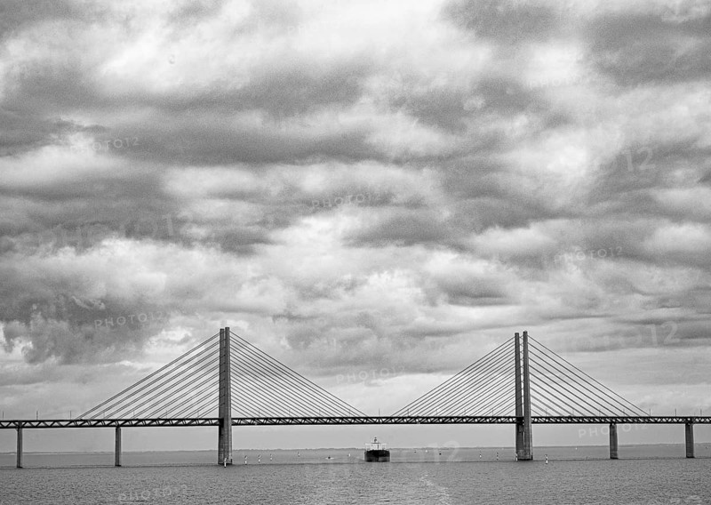 Dramatic clouds in the sky over the Öresund Bridge between Malmö and Copenhagen, painted in black and white, monochrome, Øresund, Skane län, Sweden