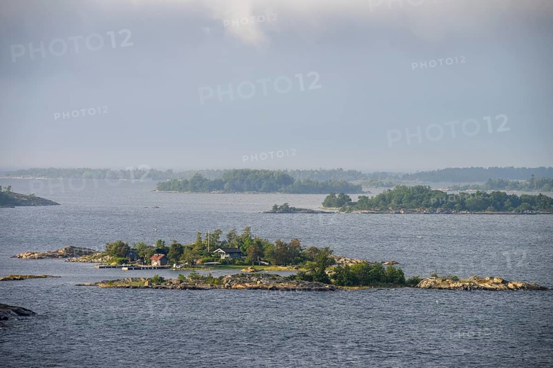 Small islands in the sea under a cloudy sky, calm and peaceful atmosphere, Aland Archipelago, Finland