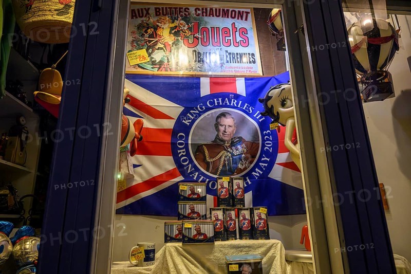 Street scene in the old town of Naantali, A decorated shop window with flag and King Charles II motif, Naanatali, Varsinais-Suomi, Finland