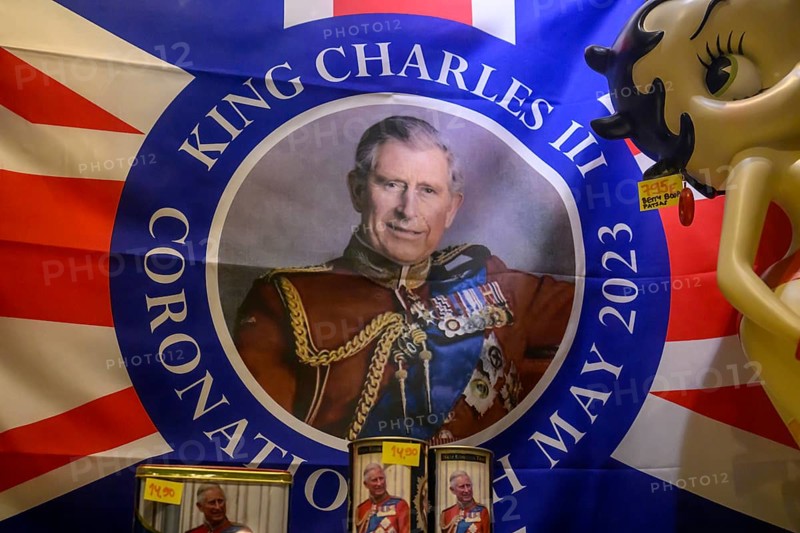 Street scene in the old town of Naantali, colorful flag with portrait of King Charles III and coronation motif, window display, Naanatali, Varsinais-Suomi, Finland