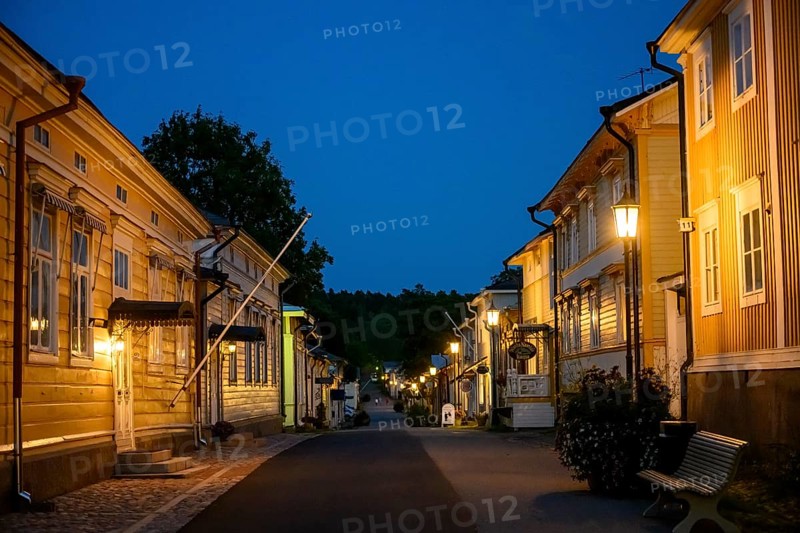 Street scene in the old town of Naantali at night with warmly lit houses, Naanatali, Varsinais-Suomi, Finland