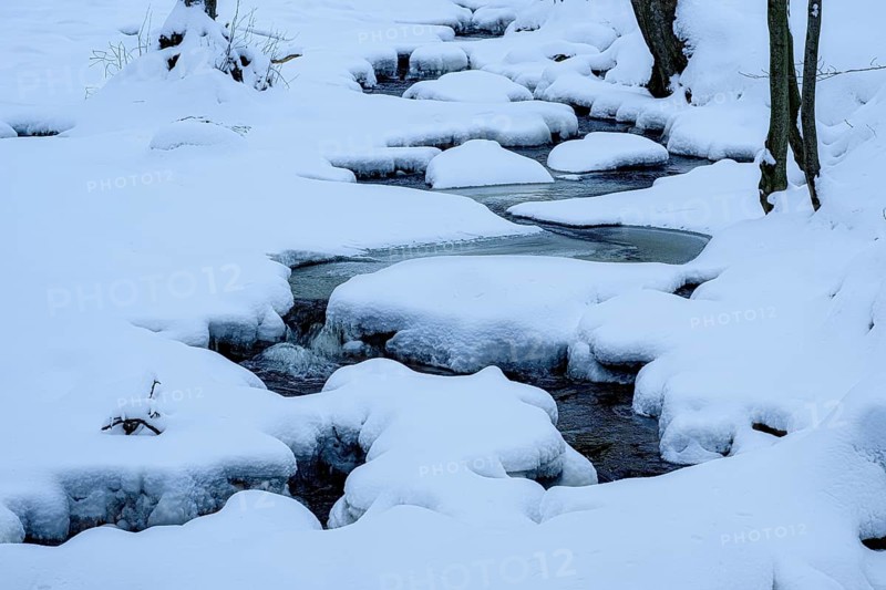 Ilsenburg, Saxony-Anhalt, Germany, path of a snowy little river Ilse in the Harz National Park on Heinrich-Heine trail Ilsetal covered with ice