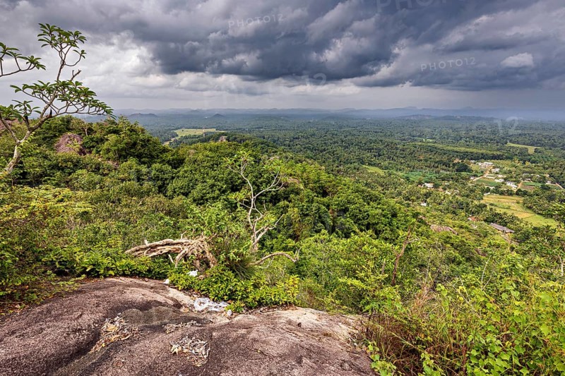 Far-reaching view of green forests and valleys under a dramatic cloudy sky, The landscape in the mountains near Colombo Sri Lanka