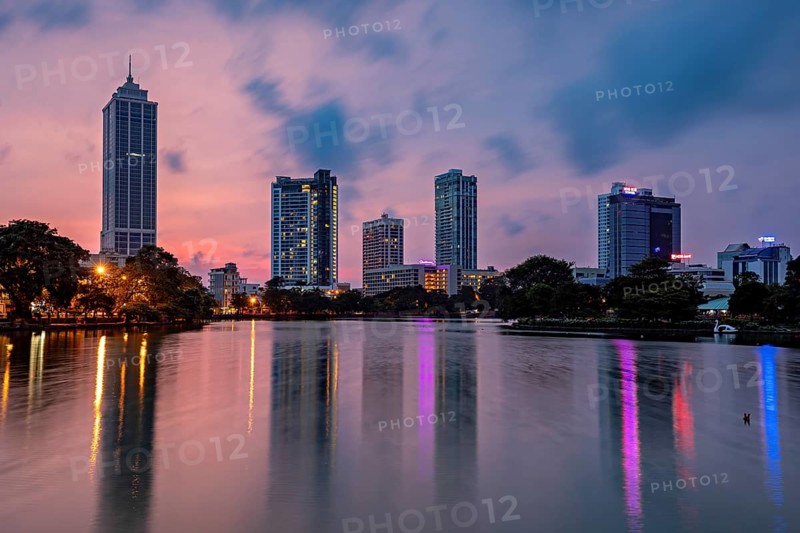 City view at dusk with illuminated skyscrapers and colorful reflections in the river, the skyline of Colombo Sri Lanka at night