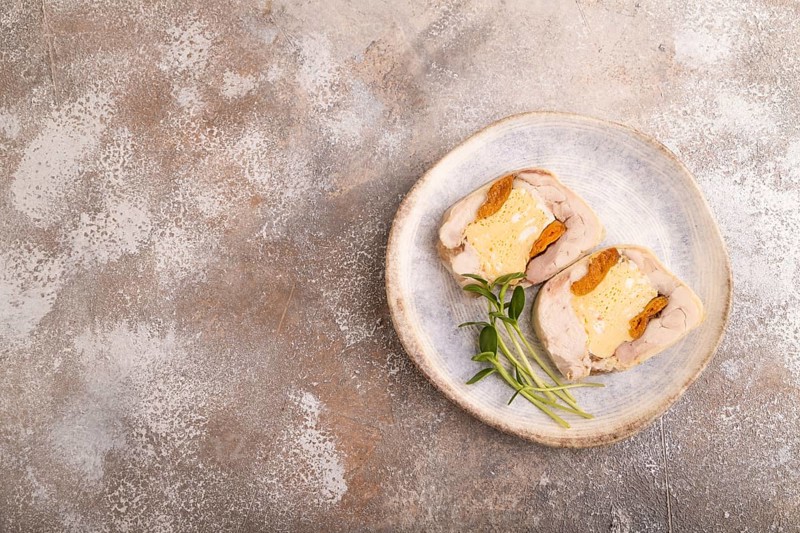 Chicken, egg and dried apricot meatloaf, microgreen on brown concrete background. top view, flat lay, copy space