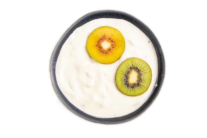 Yogurt, with kiwi in blue bowl isolated on white background, top view, flat lay, close up, minimalism
