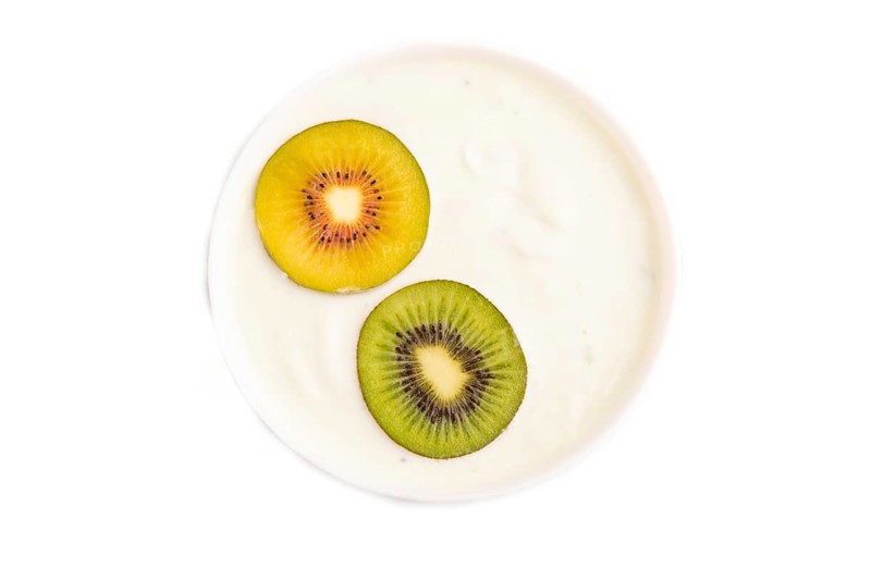 Yogurt with kiwi in white bowl Isolated on white background, top view, flat lay, copy space, minimalism