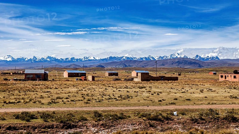 Small houses in the countryside with mountain views and blue skies, The Altiplano landscape in the Andes of Bolivia